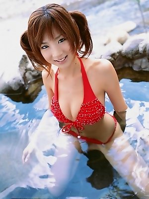 Dreamy cute gravure idol with pig tails in a red skimpy bikini